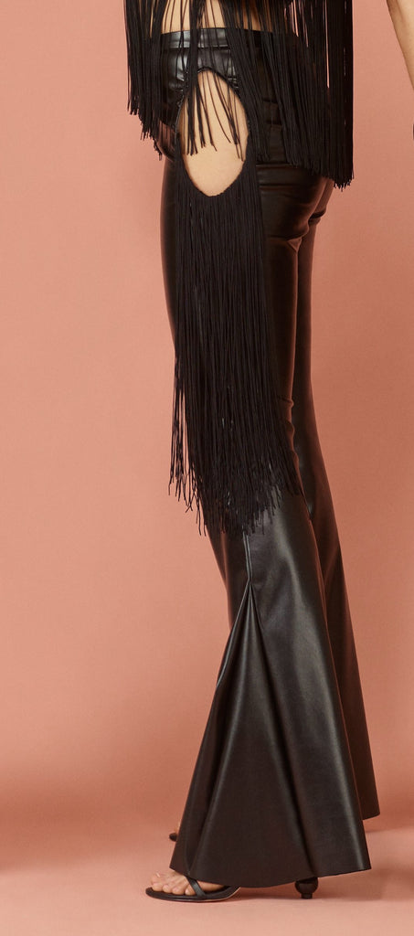 Close up view of vegan leather jean silhouette with close up of circle cut out at hips.