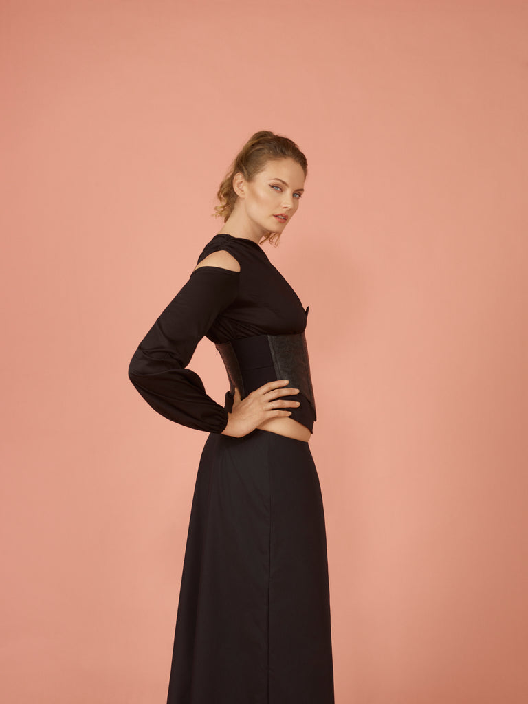 Side view of black asymmetric draped top paired with Western Saddle Corset and Wide leg pant in black.