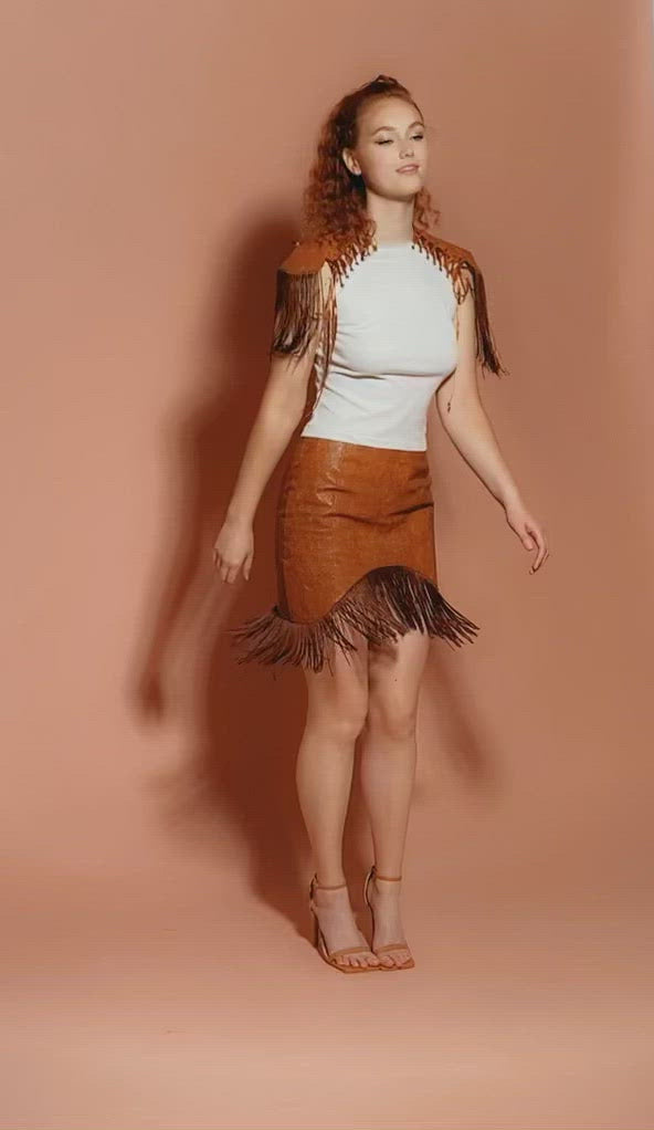 model dancing in brown fringe mini skirt